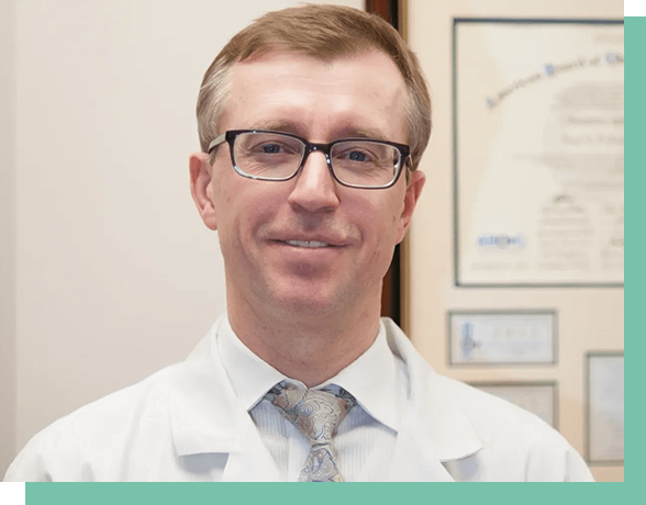 A man in white lab coat and glasses.